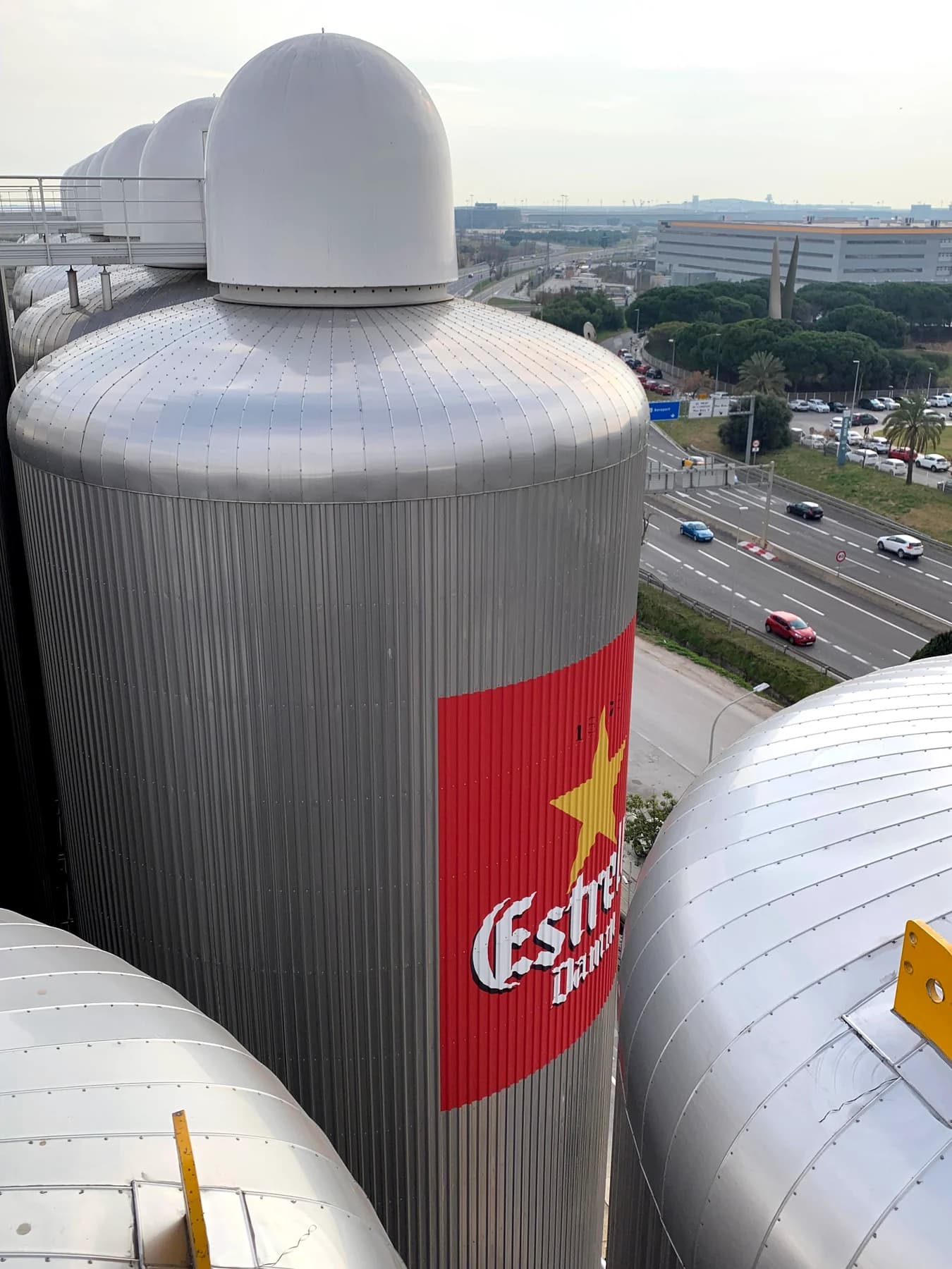 Estrella Damm branded tank in an industrial brewery production facility